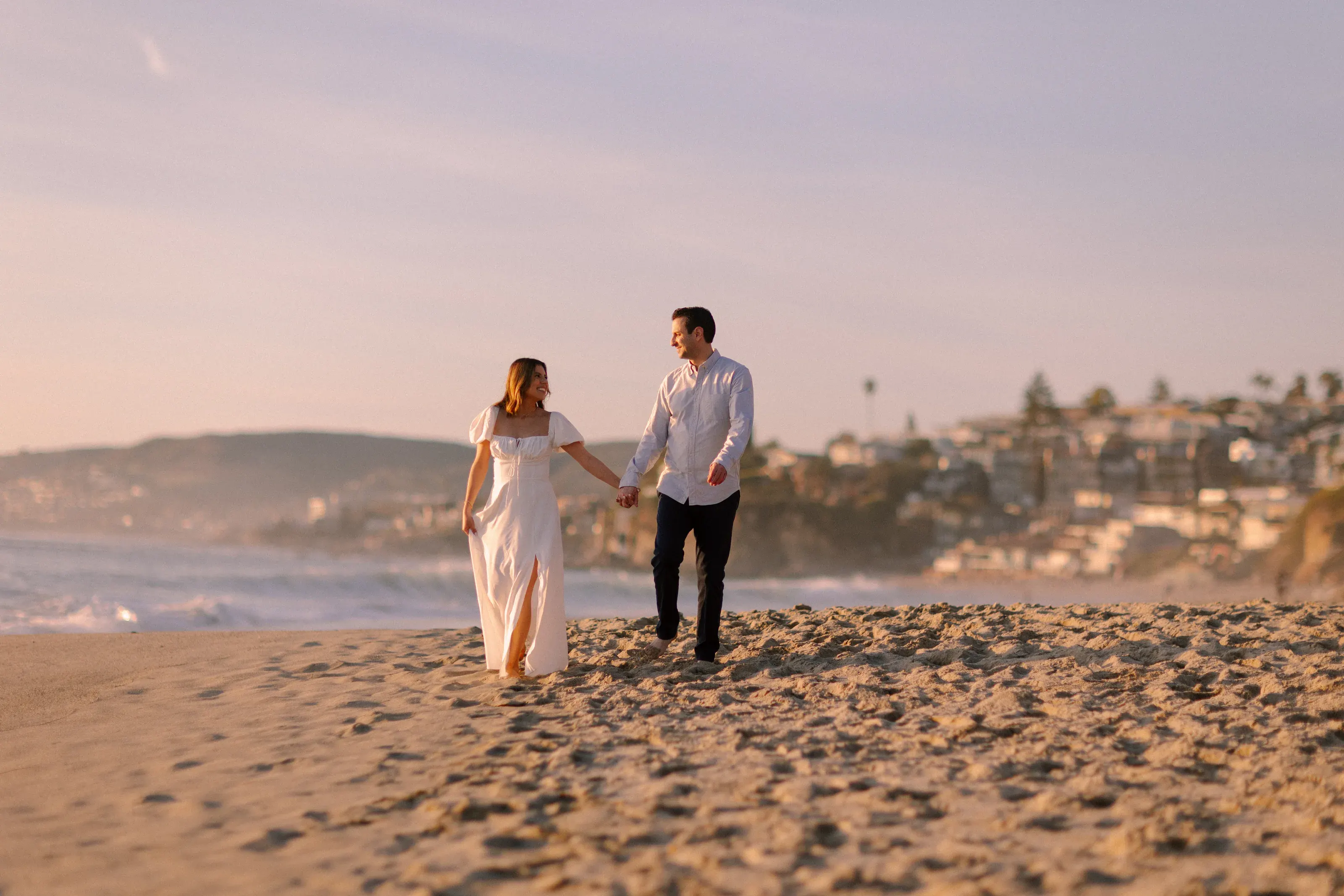 Wide engagement portrait above the beach
