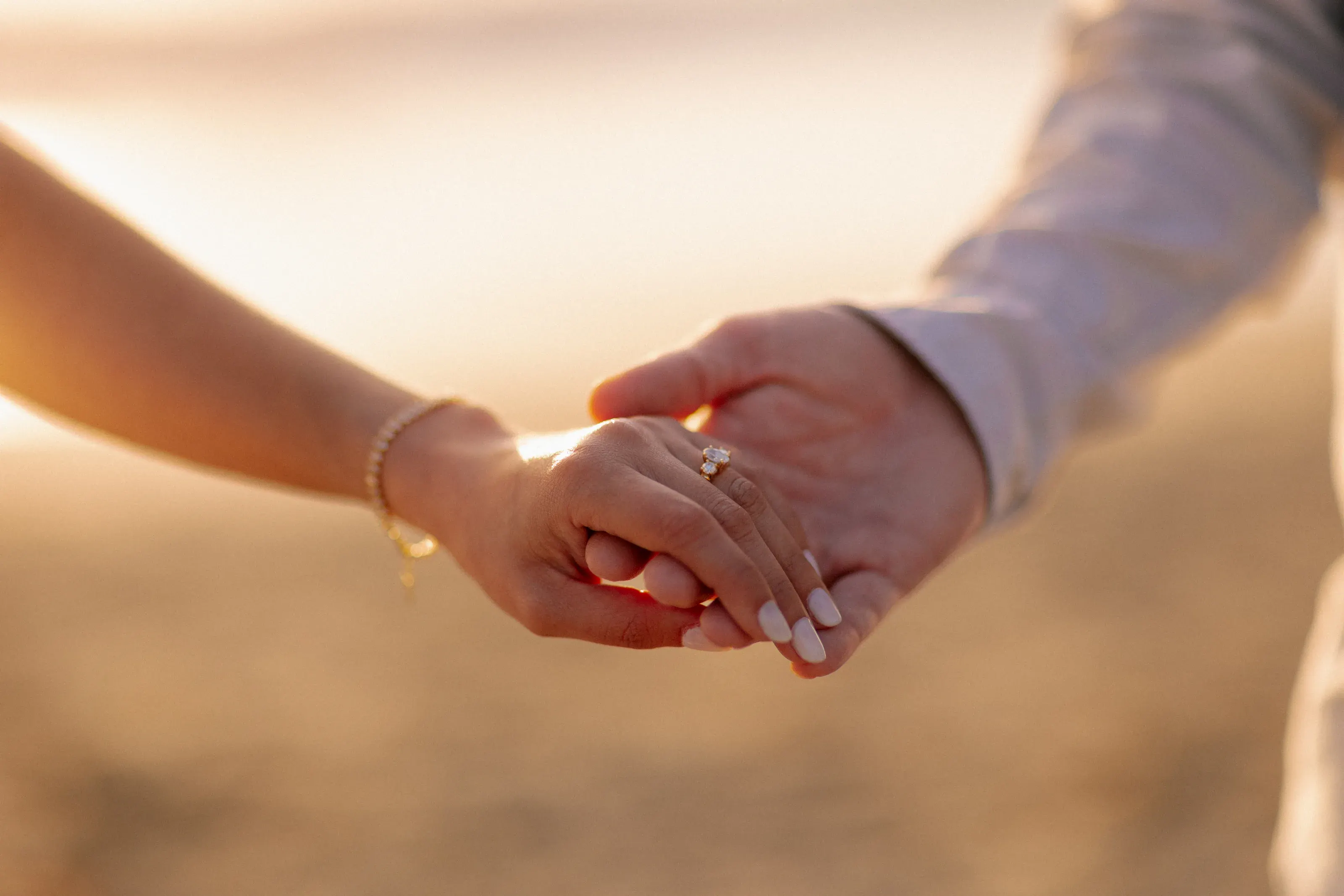 Close engagement-ring detail in warm evening light