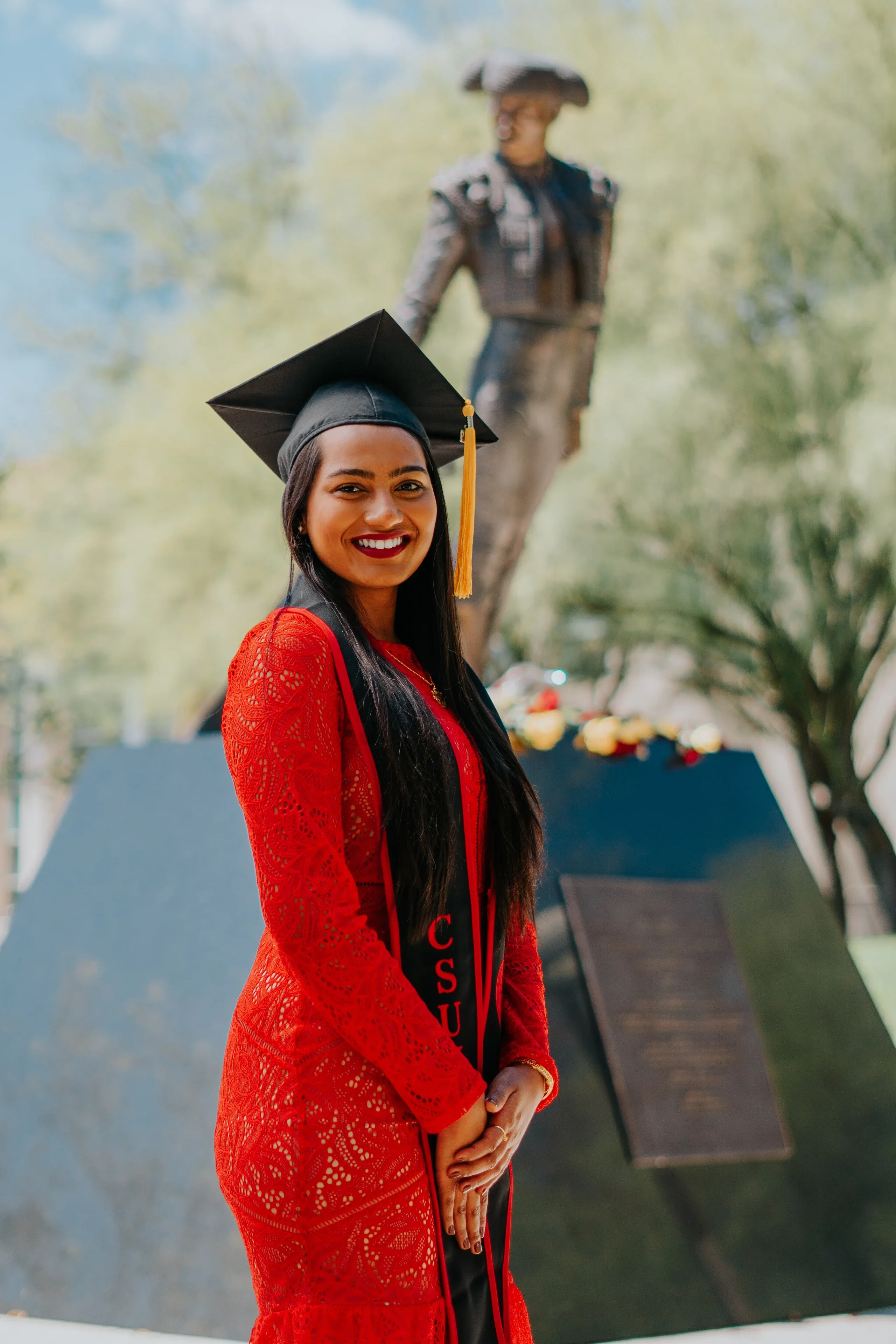 Close graduation portrait with Cal State Fullerton stole and honors cords