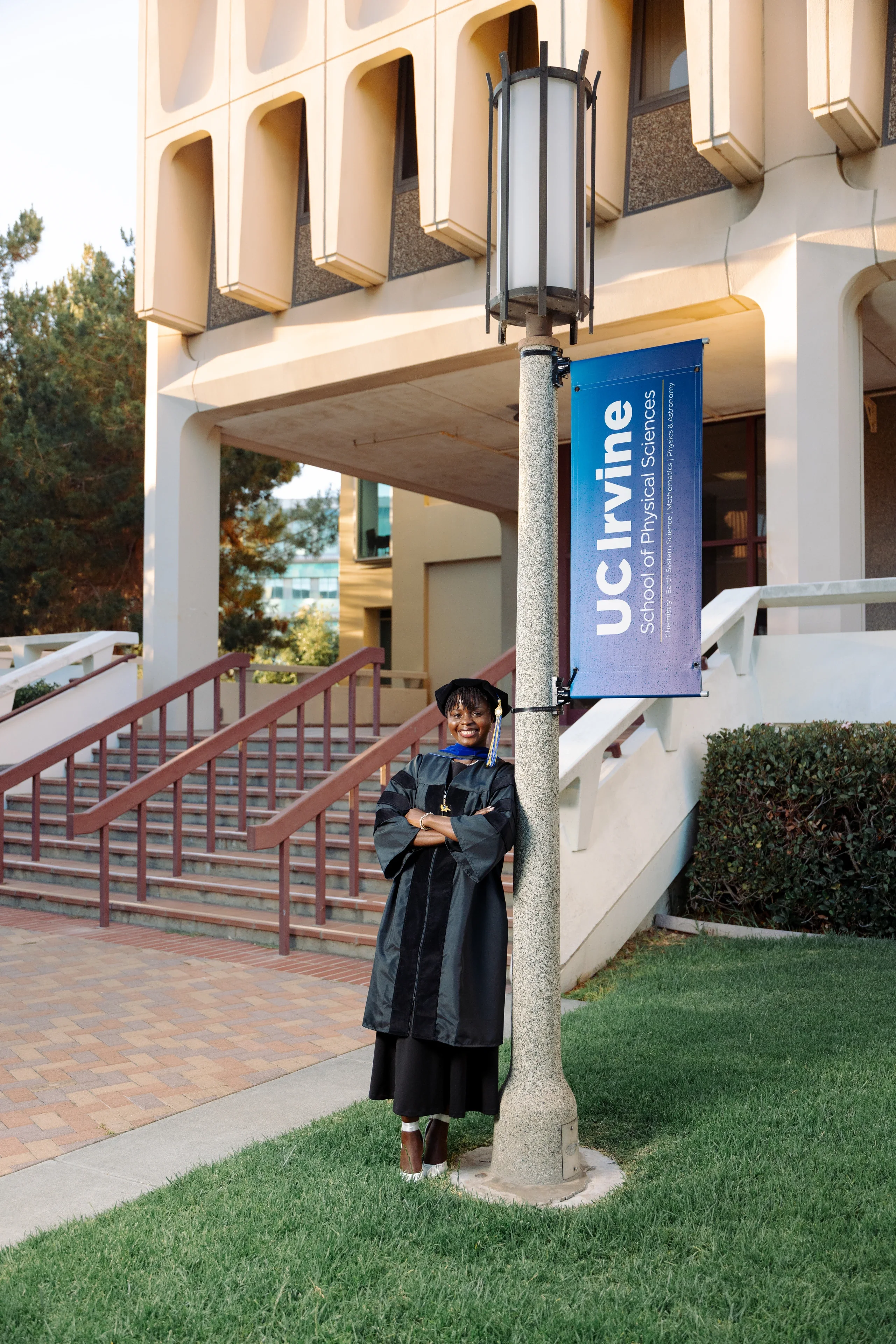 UC Irvine graduate photographed beneath recognizable campus architecture