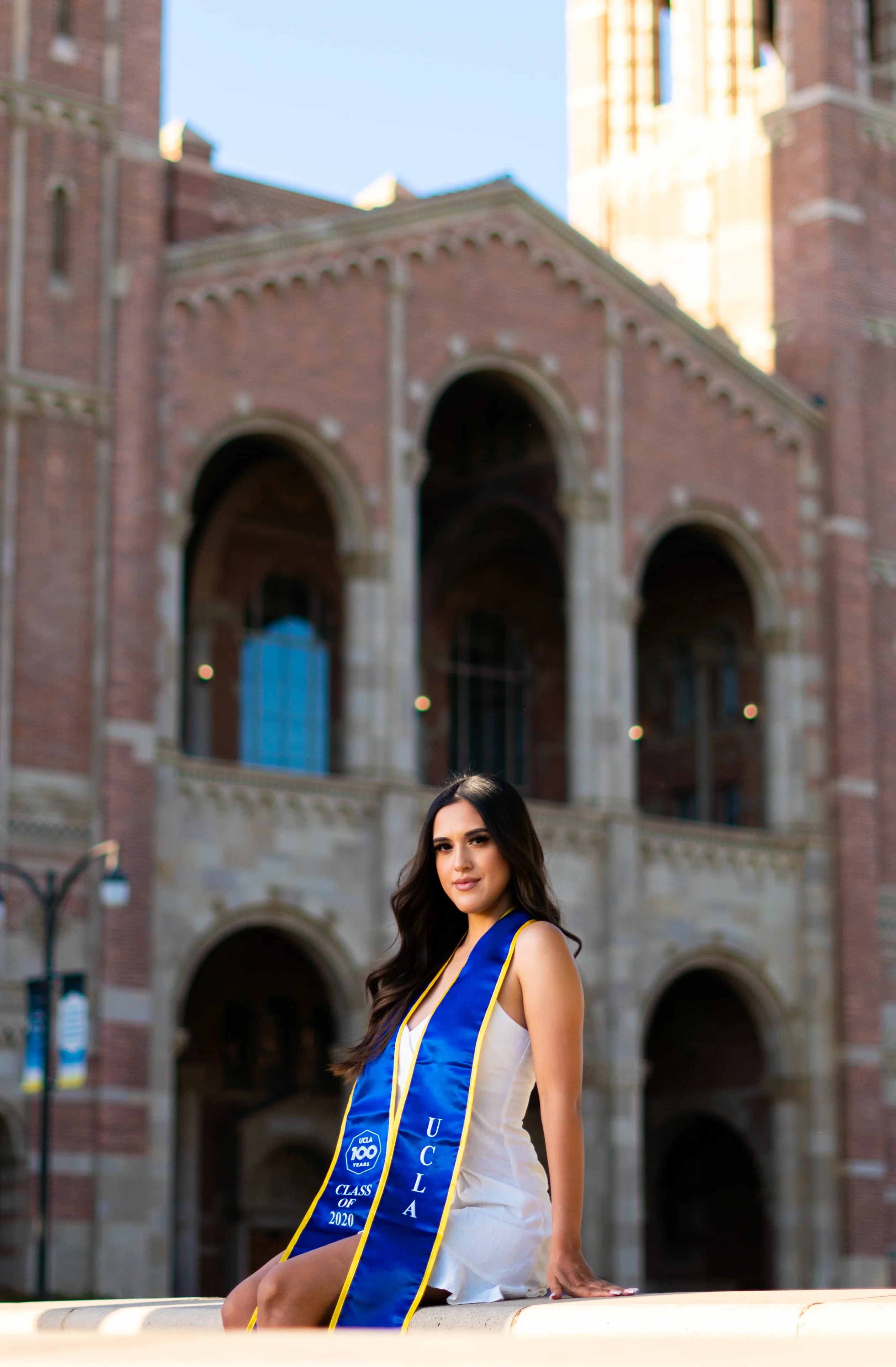 UCLA graduate seated for a cinematic campus portrait