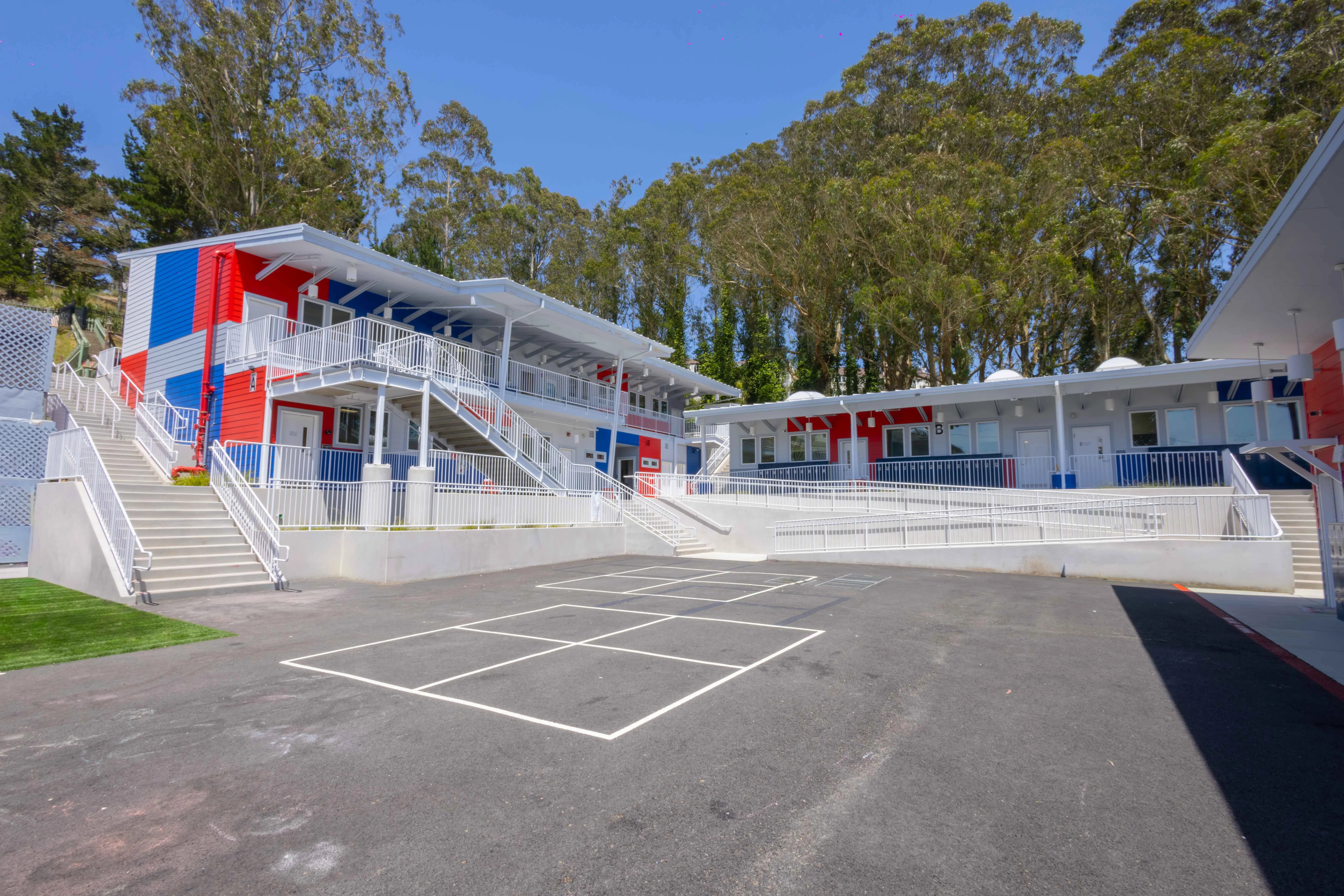 Wide exterior photograph showing the full Hilldale property