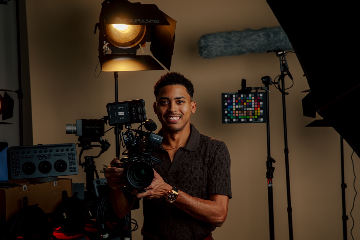 Michael Merchan holding a cinema camera in his studio
