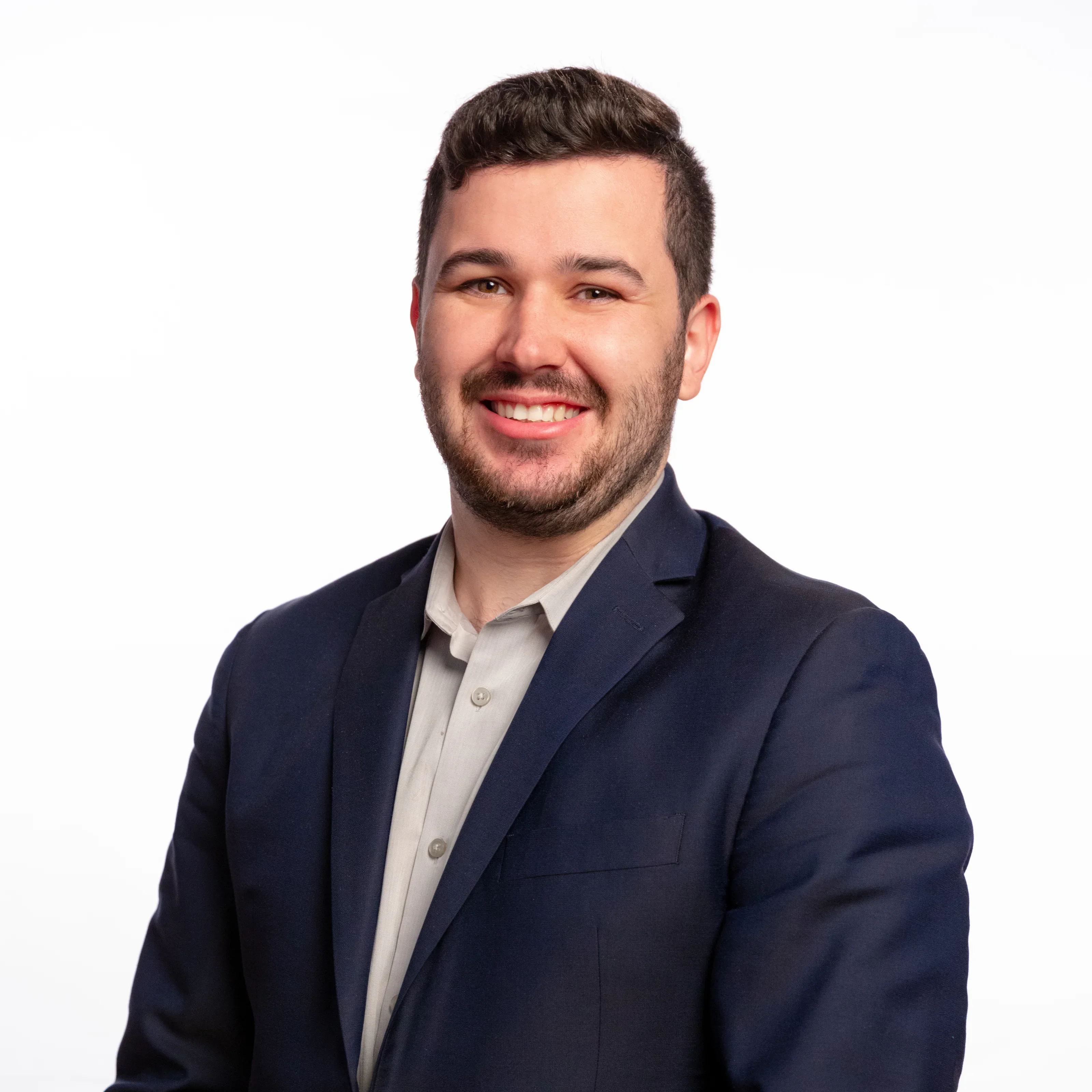 Professional studio headshot in a dark suit and white shirt