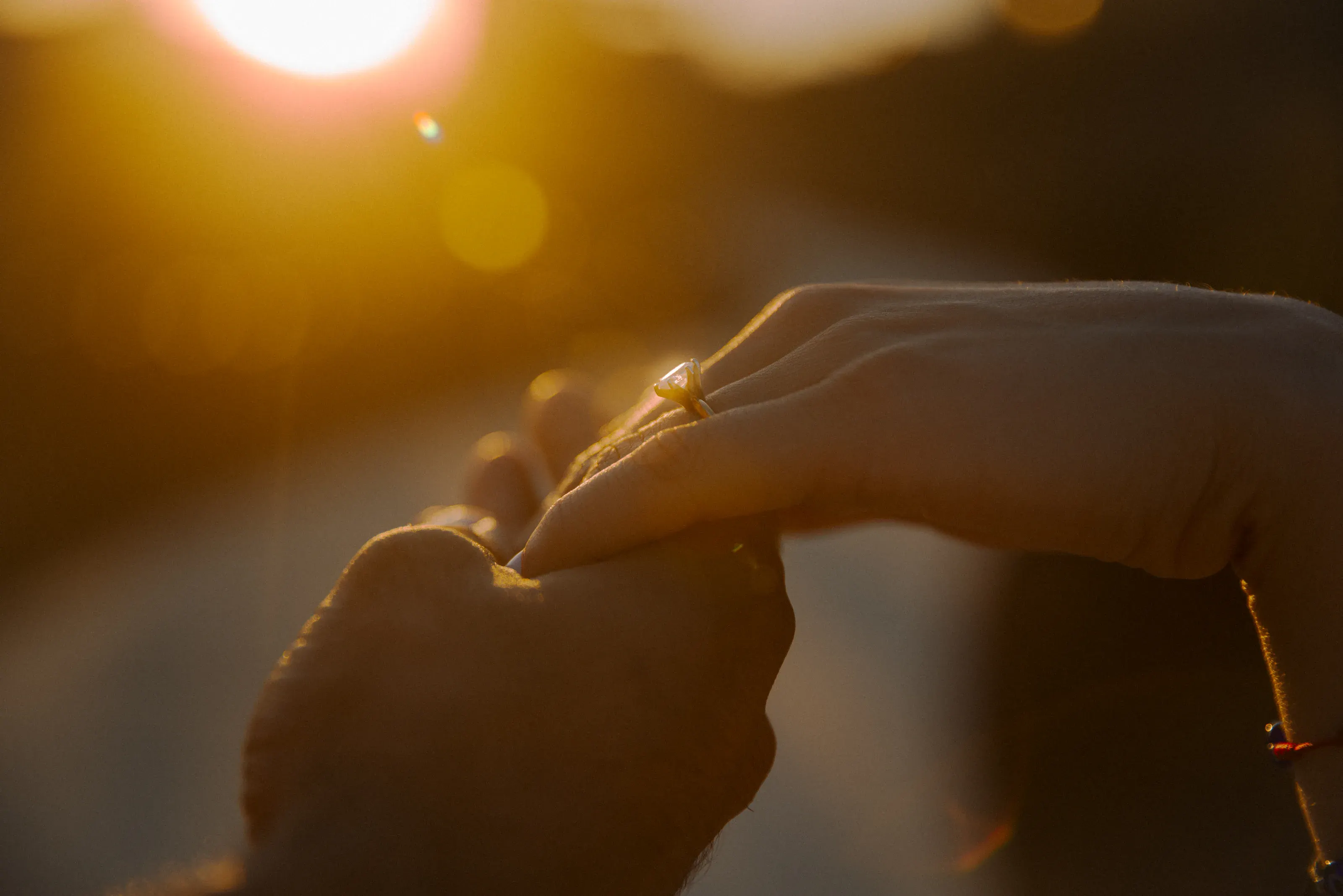 Close detail of the engagement ring in sunset light