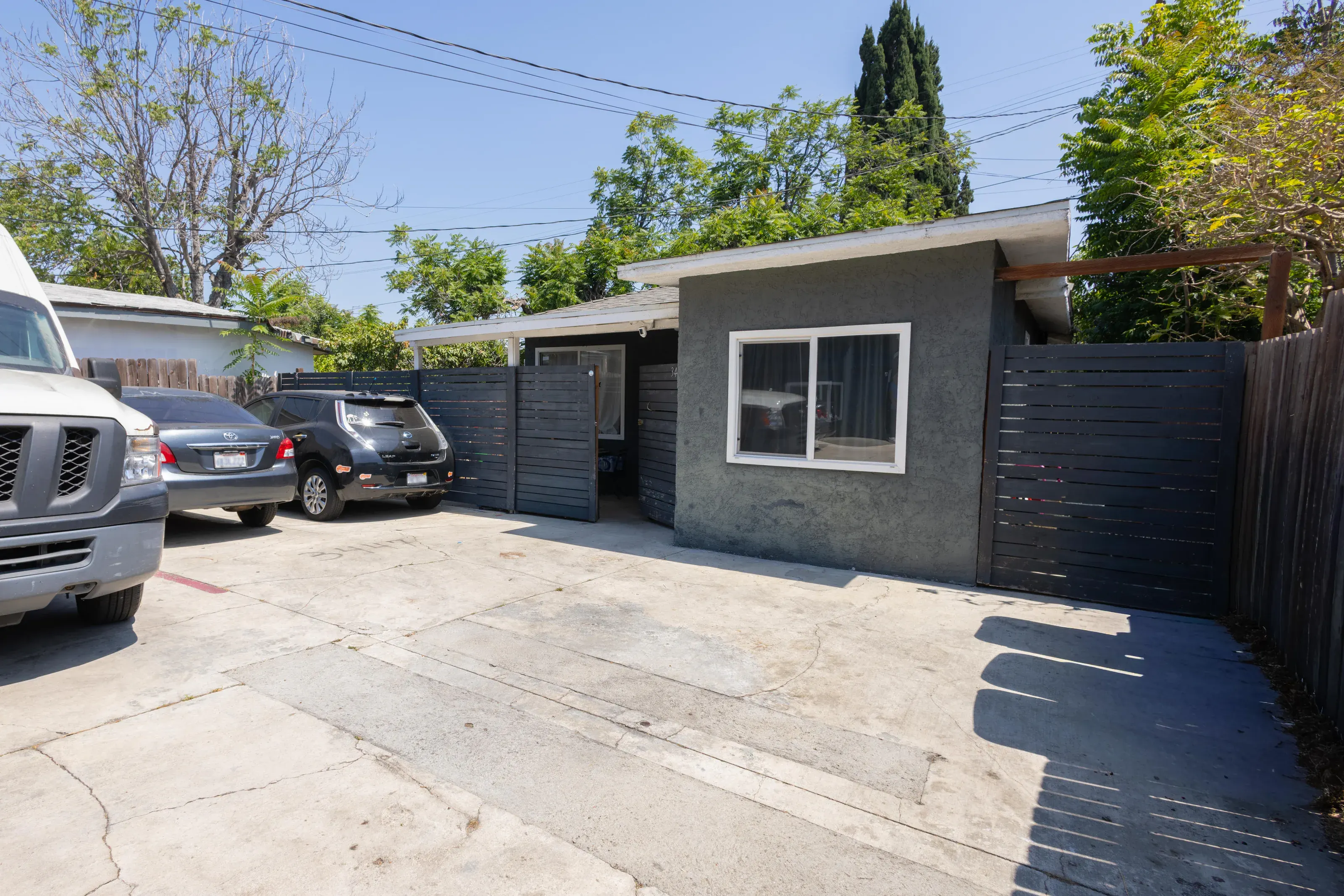 Rear unit and parking area documented for a multi-unit listing
