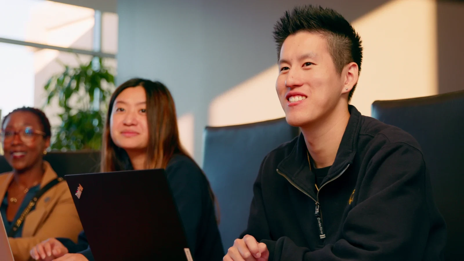 UCI students collaborating around a laptop in Opening Doors at UCI