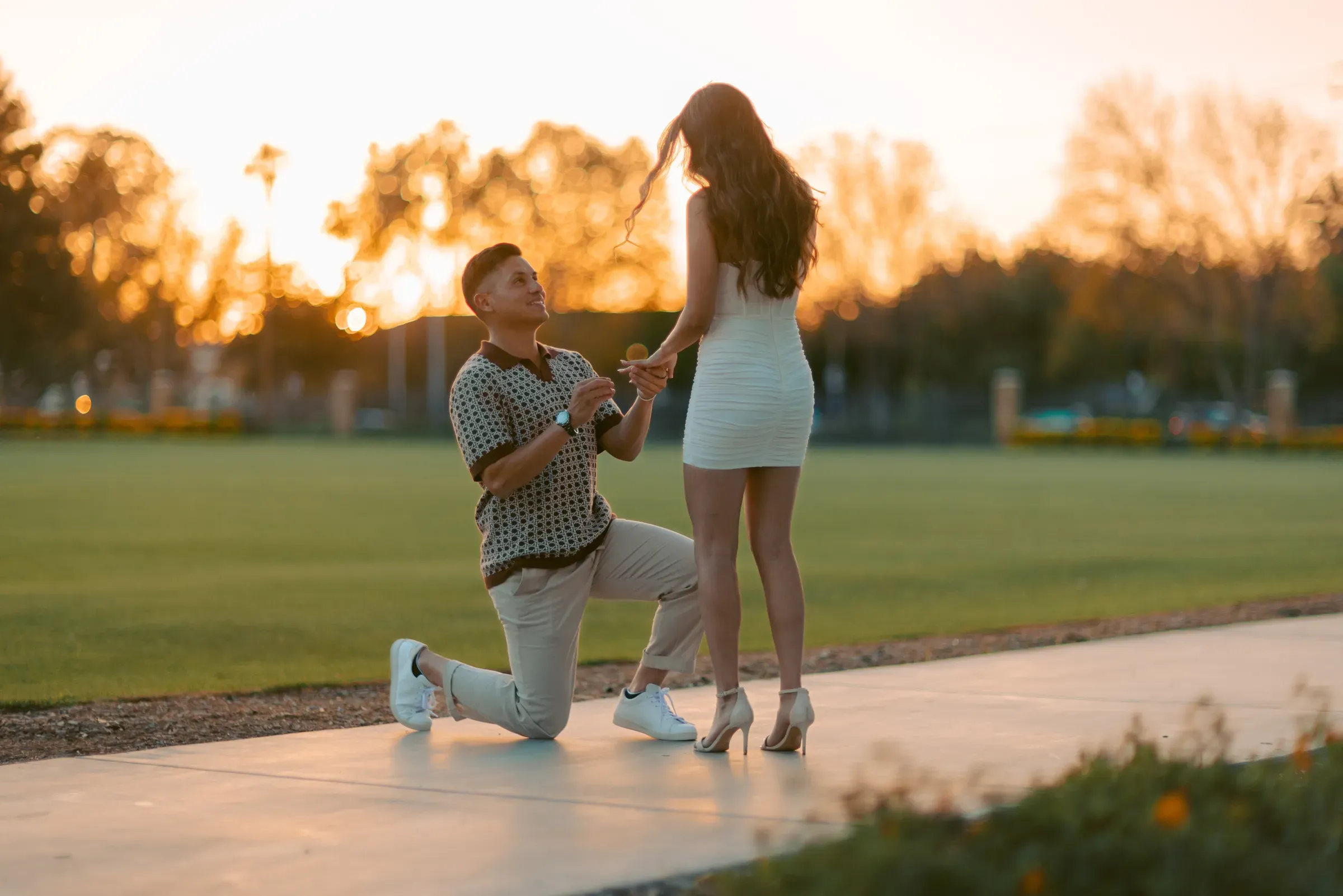 She said yes — proposal moment in warm evening light