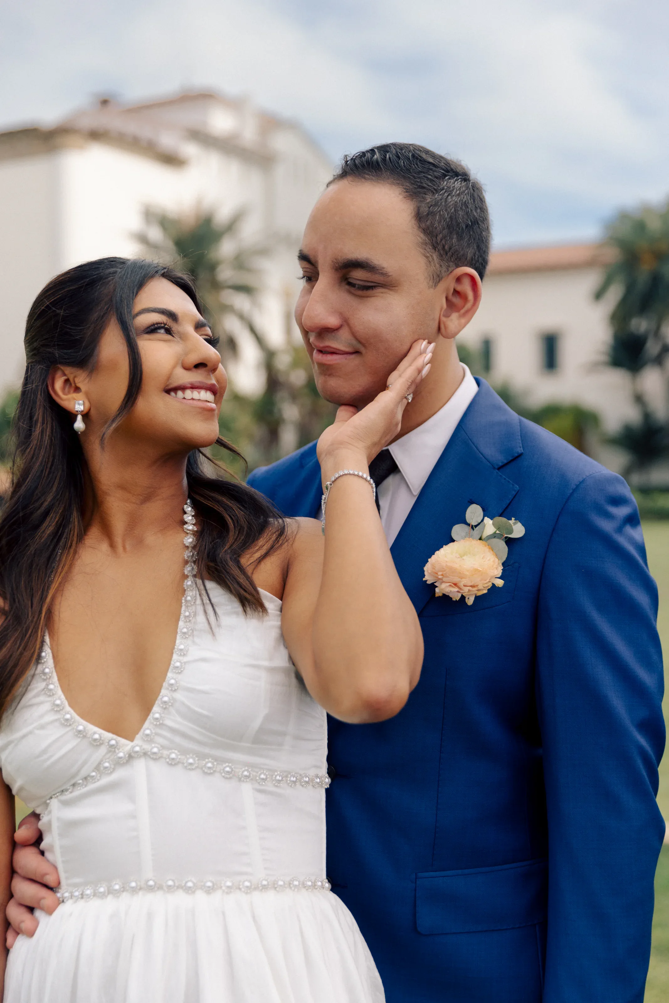 Intimate newlywed portrait with the courthouse architecture behind them