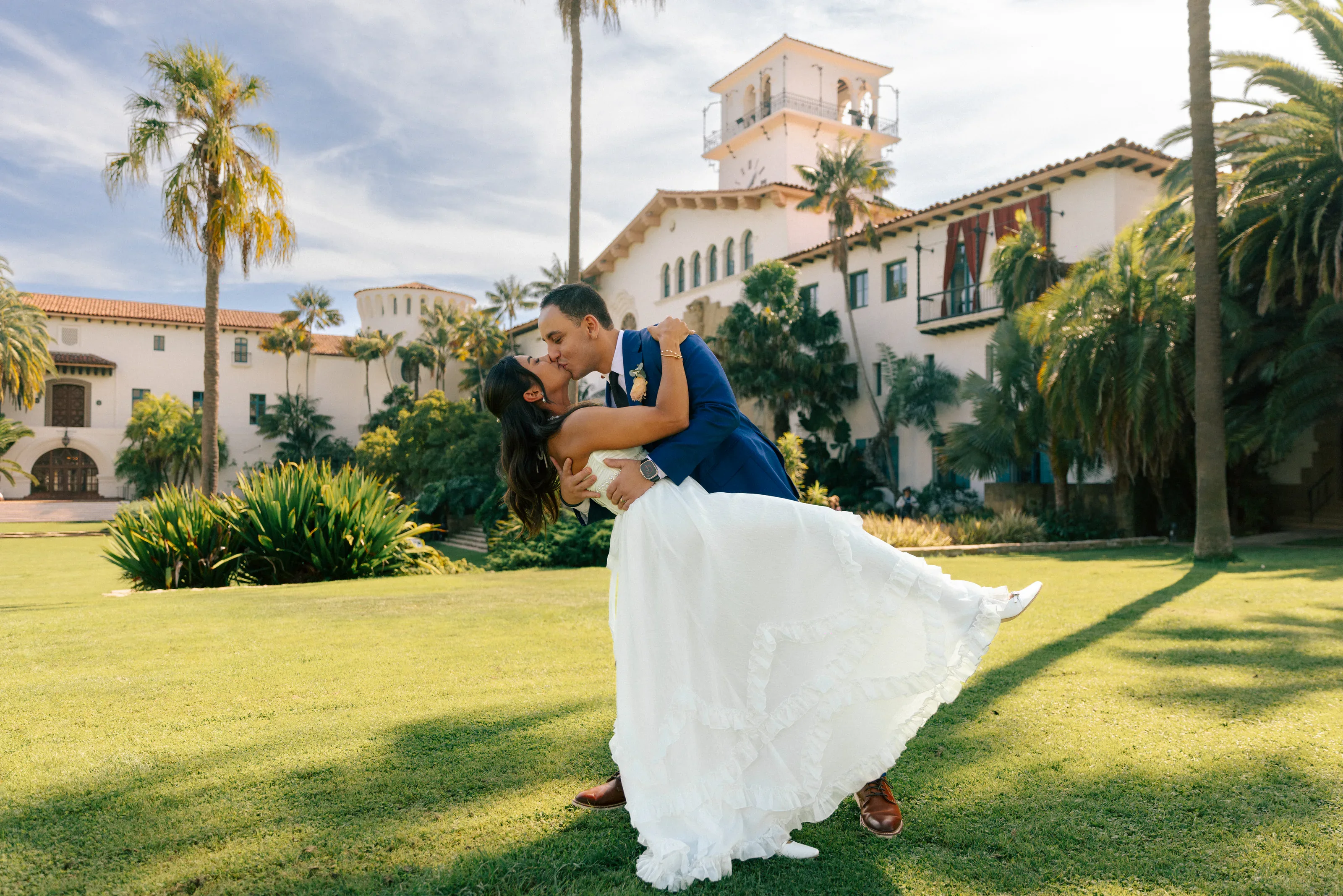 Newlyweds embracing on the courthouse lawn after the ceremony